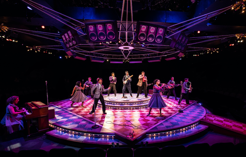 Buddy Holly & the Crickets on a circular dais raised above a round stage with dancers in a circle around them.